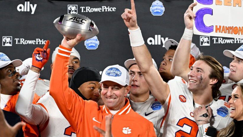 Clemson Tigers head coach Dabo Swinney, quarterback Cade Klubnik and teammates celebrate after winning the ACC Championship game