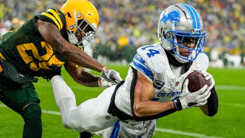 Detroit Lions wide receiver Amon-Ra St. Brown catching a TD pass against Green Bay Packers cornerback Keisean Nixon
