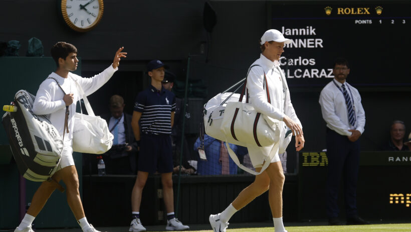 Carlos Alcaraz and Jannik Sinner walking onto the court at Wimbledon 2025