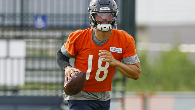 Chicago Bears quarterback Caleb Williams runs with the ball during training camp
