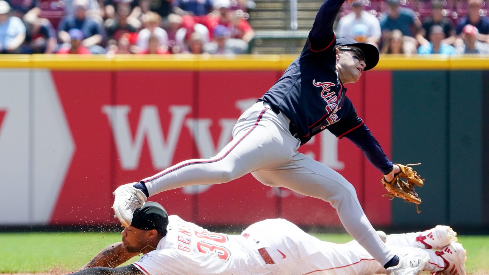 Cincinnati Reds center fielder Will Benson slides into second as Atlanta Braves shortstop Nick Allen covers the base