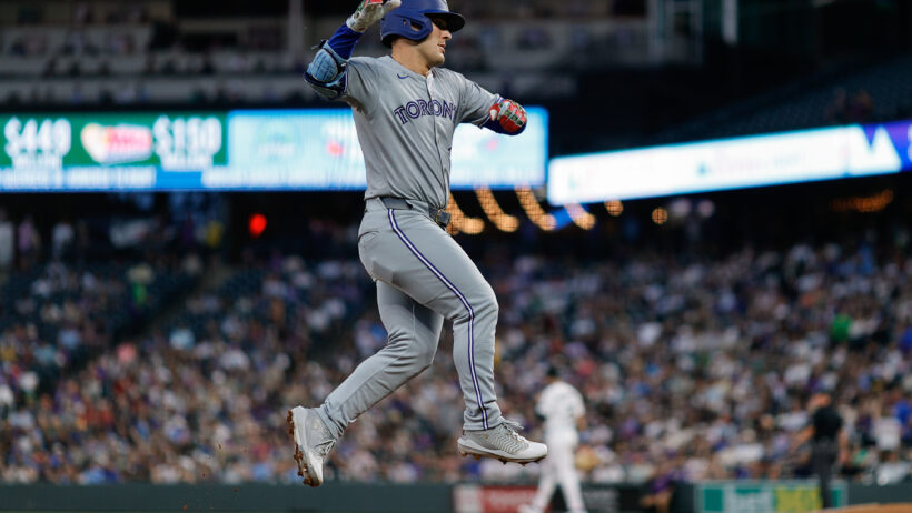 Daulton Varsho celebrates while rounding the bases after a home run