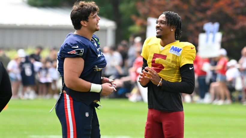 New England Patriots offensive tackle Will Campbell talks to Washington Commanders quarterback Jayden Daniels at joint practice