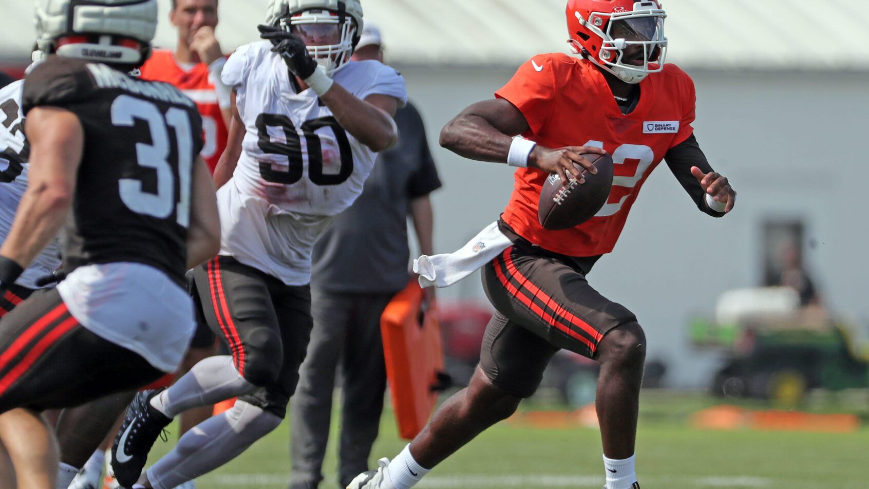 Shedeur Sanders escapes the pocket for short gain during training camp.
