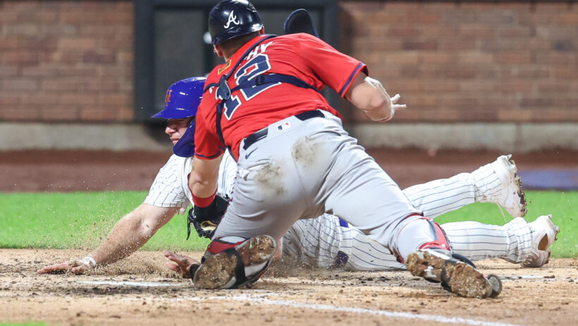 Atlanta Braves catcher Sean Murphy tagging out New York Mets first baseman Pete Alonso
