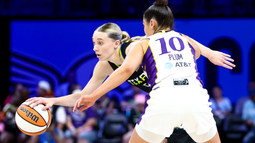 Dallas Wings guard Paige Bueckers dribbles while Los Angeles Sparks guard Kelsey Plum defends