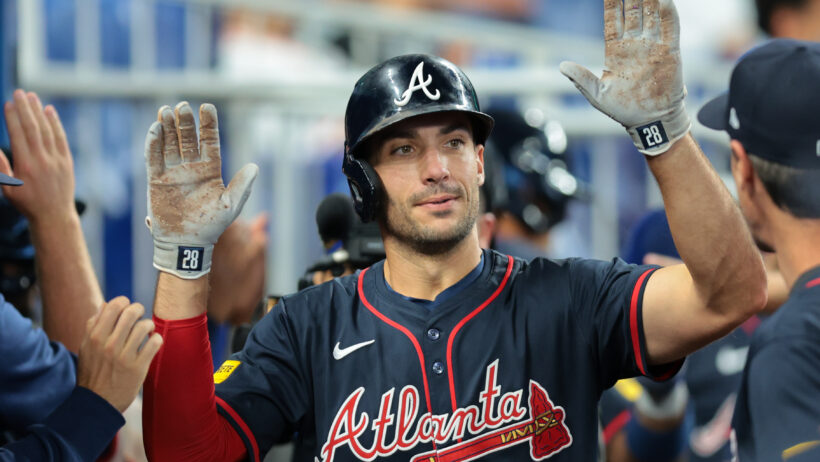 Matt Olson celebrates in the dugout after hitting a home run