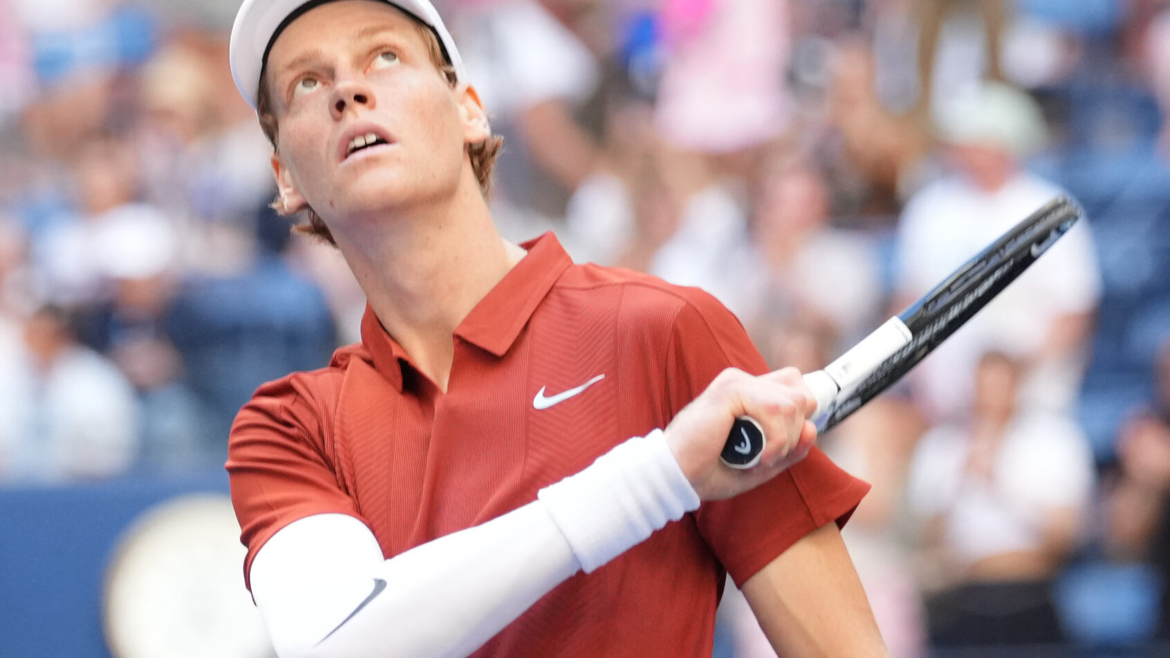Jannik Sinner swats a ball into the crowd after winning his 3rd Round US Open match.