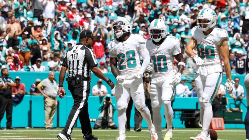 Devon Achane and Tyreek Hill celebrating after a touchdown