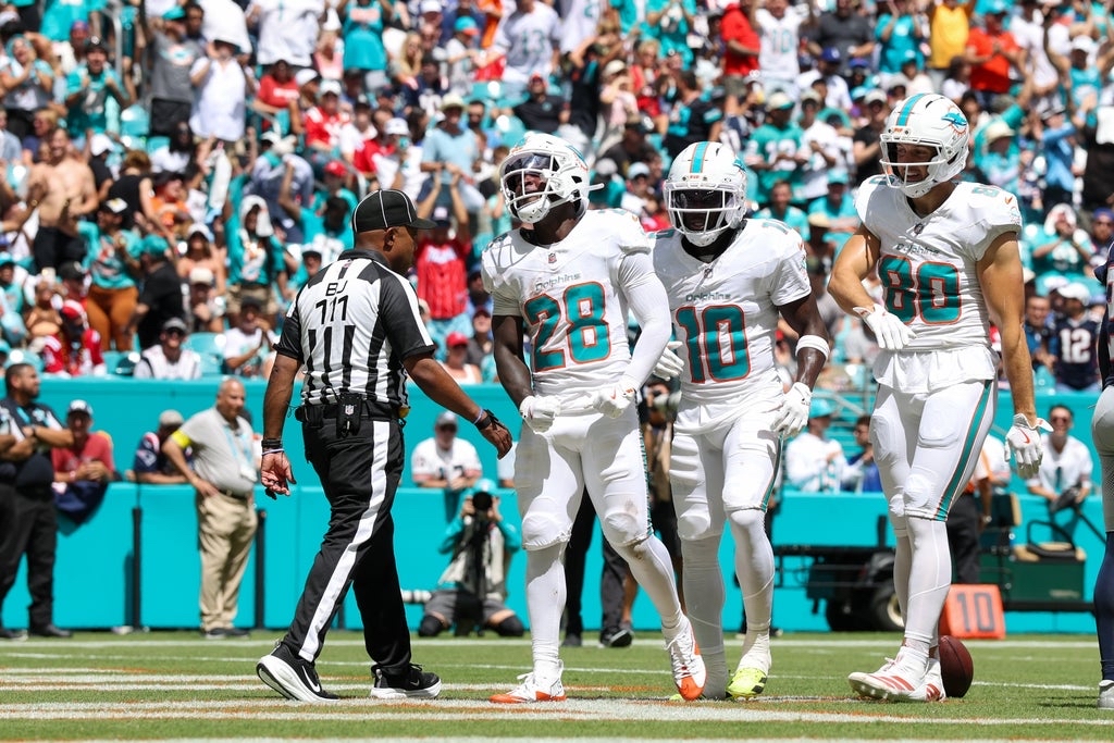 Devon Achane and Tyreek Hill celebrating after a touchdown