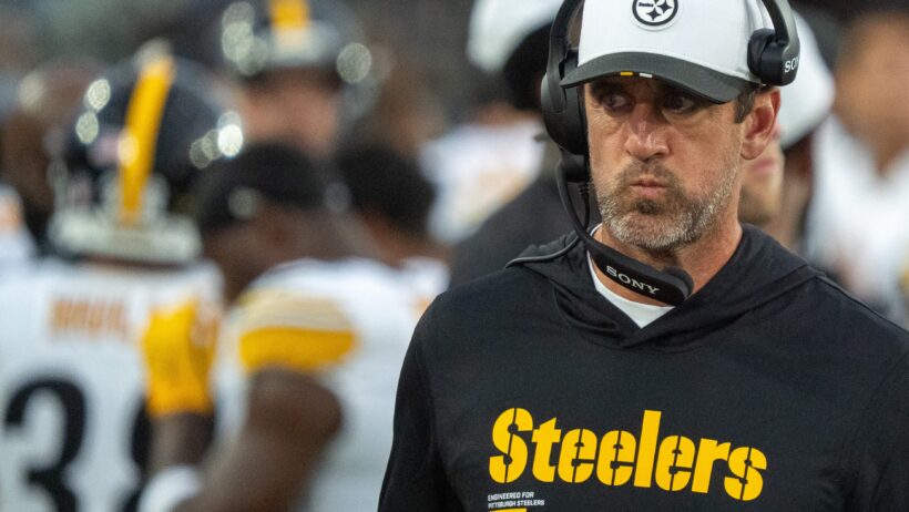 Aaron Rodgers looks on from the sidelines during a Steelers preseason game.