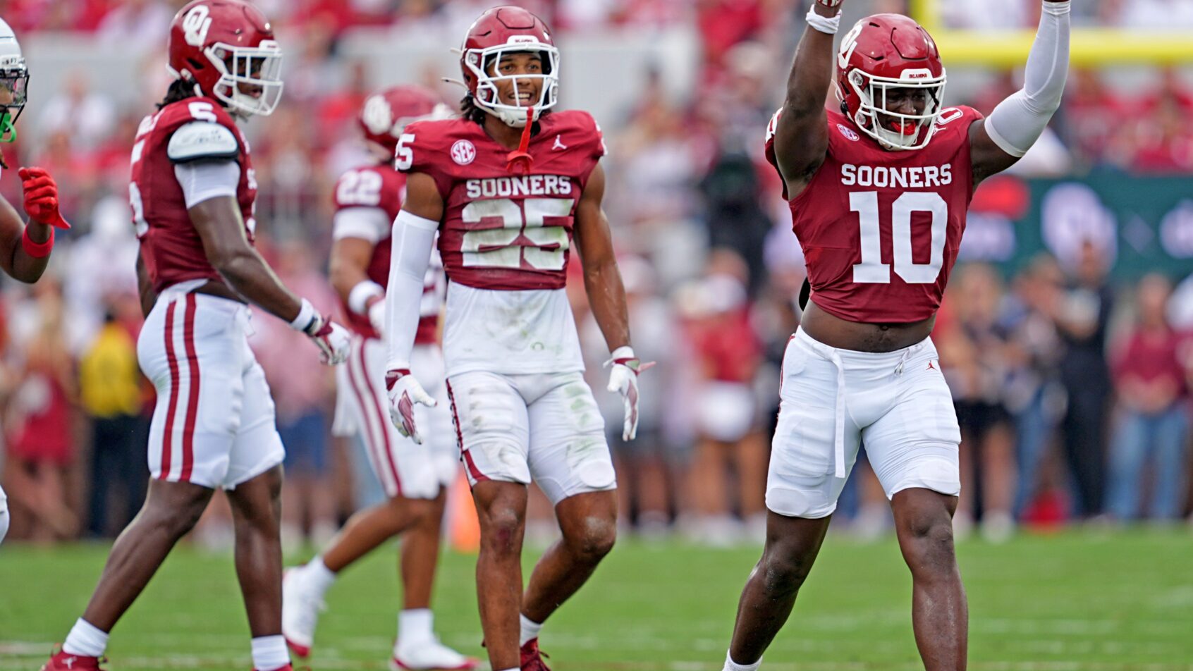 Oklahoma's Kip Lewis celebrates in the first half of the college football game