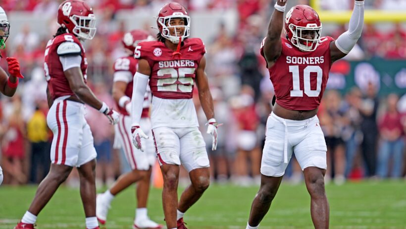 Oklahoma's Kip Lewis celebrates in the first half of the college football game