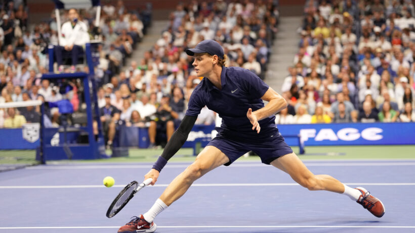 Jannik Sinner hitting a backhand volley at the 2025 US Open