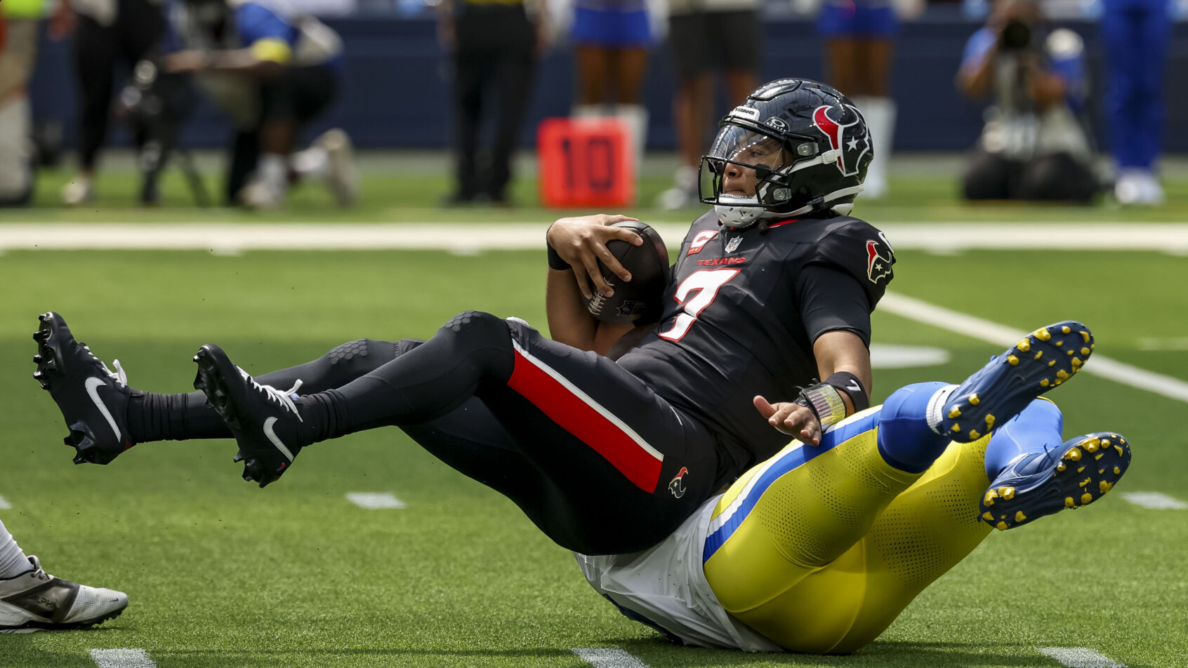 Houston Texans quarterback C.J. Stroud gets sacked by Los Angeles Rams linebacker Byron Young