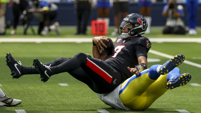 Houston Texans quarterback C.J. Stroud gets sacked by Los Angeles Rams linebacker Byron Young