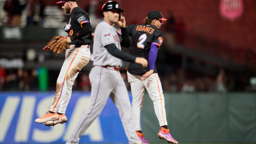 San Francisco Giants infielders celebrate a win after the final out against the Arizona Diamondbacks