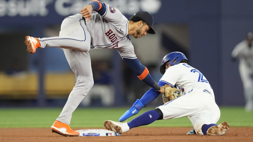 Houston Astros shortstop Jeremy Pena tagging Toronto Blue Jays shortstop Ernie Clement at second base