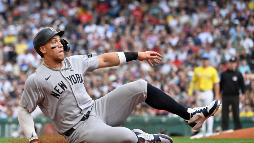 New York Yankees DH Aaron Judge sliding into third base