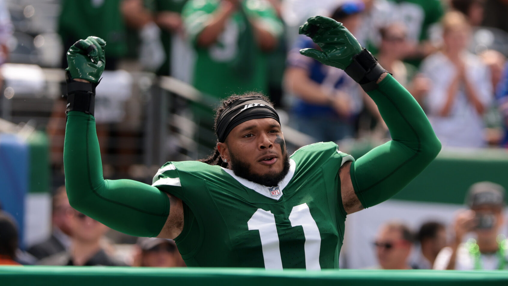 New York Jets linebacker Jermaine Johnson gestures to fans
