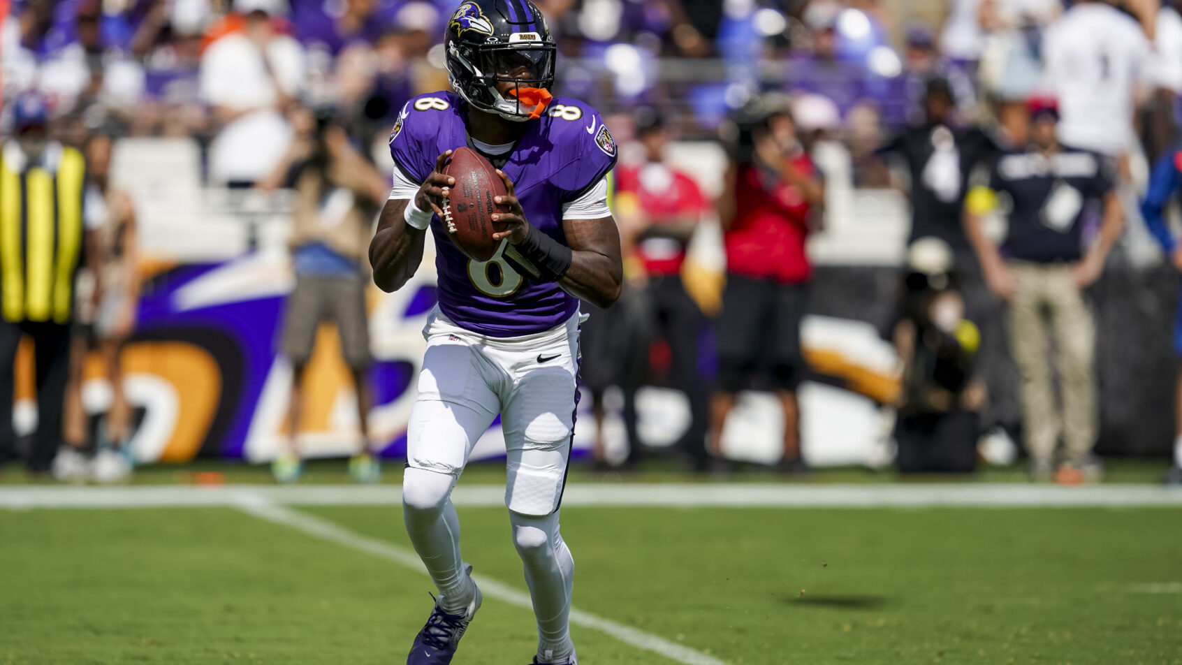 Baltimore Ravens quarterback Lamar Jackson rolling out of the pocket