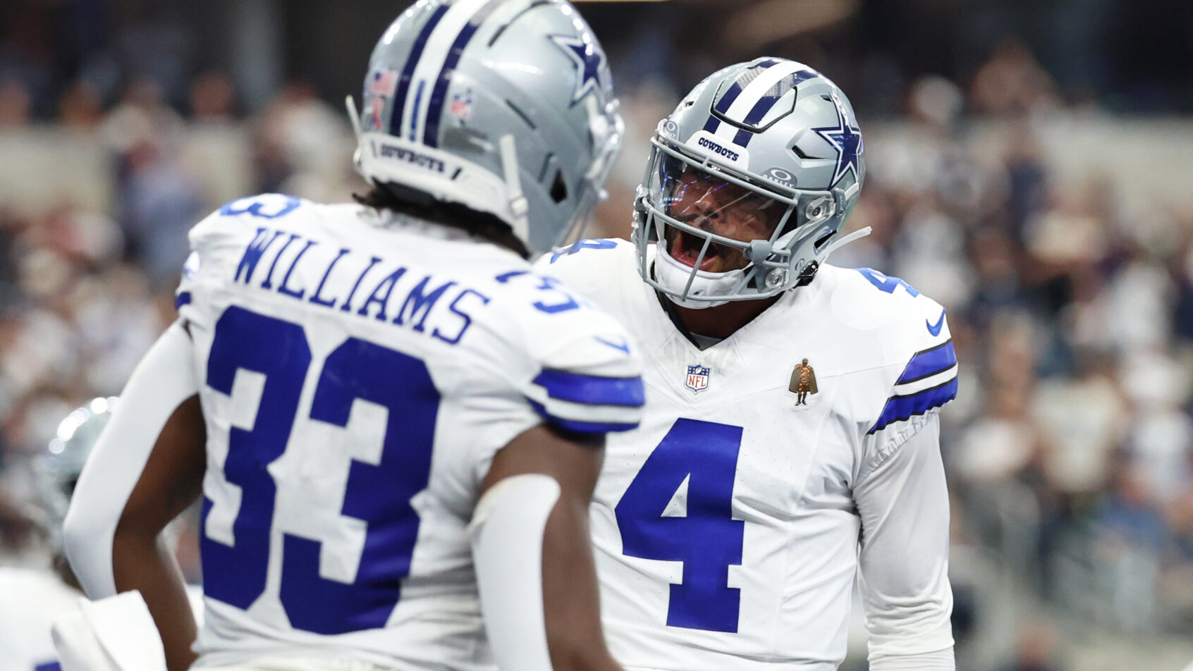 Dallas Cowboys running back Javonte Williams and quarterback Dak Prescott celebrate a TD