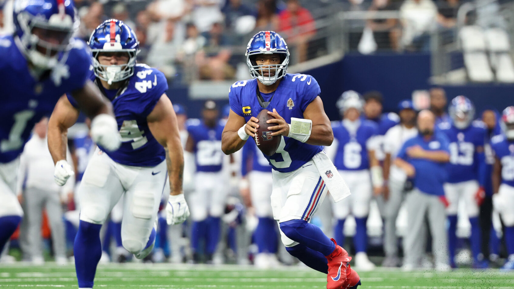 New York Giants quarterback Russell Wilson rolling out of the pocket