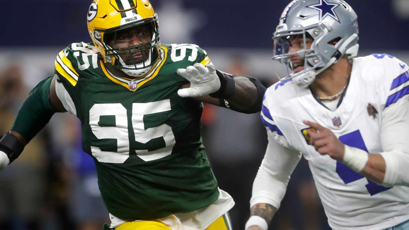 Green Bay Packers defensive tackle Devonte Wyatt chasing Dallas Cowboys quarterback Dak Prescott