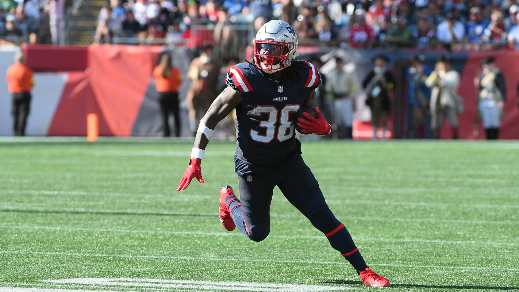 New England Patriots running back Rhamondre Stevenson runs the ball