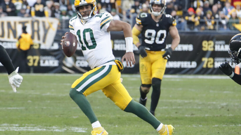 Green Bay Packers quarterback Jordan Love scrambling with the ball