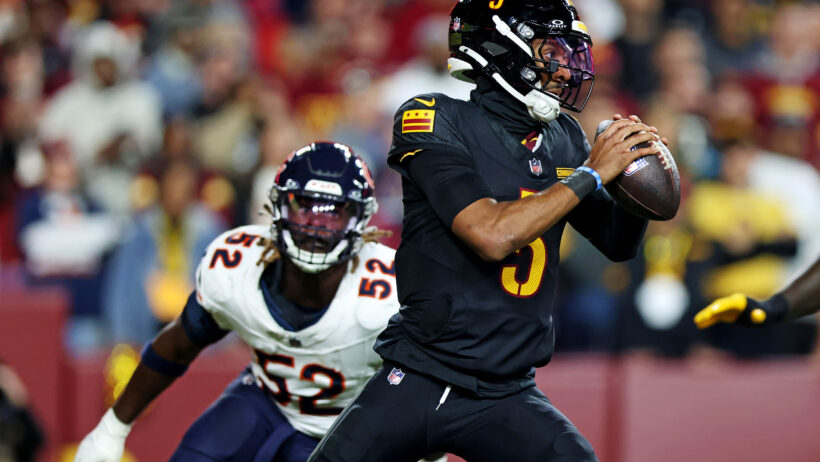 Washington Commanders quarterback Jayden Daniels holding the ball against the Chicago Bears