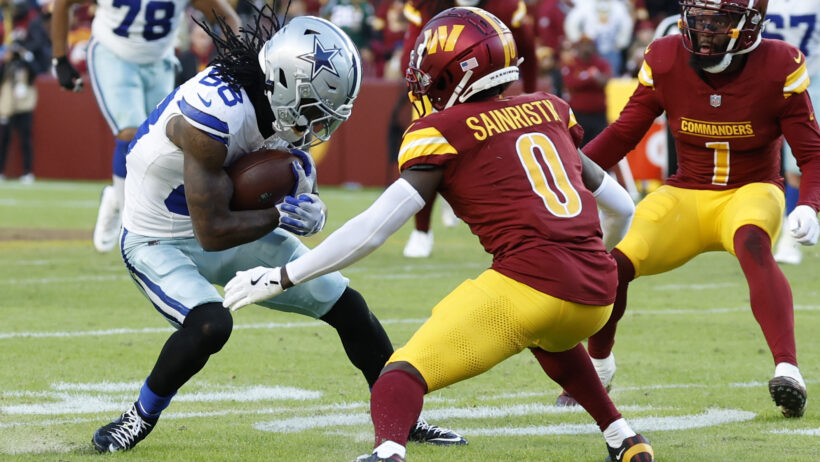 Washington Commanders cornerback Mike Sainristil tries to tackle Dallas Cowboys wide receiver CeeDee Lamb