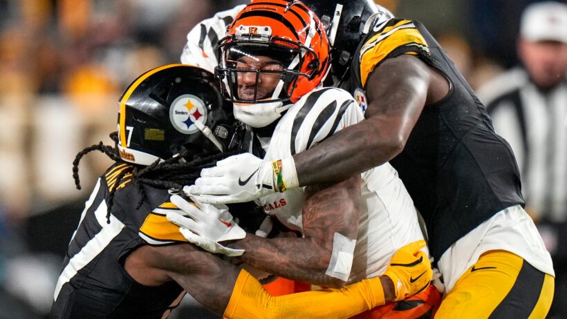 Cincinnati Bengals wide receiver Ja'Marr Chase getting tackled by two Pittsburgh Steelers