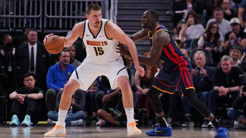 Denver Nuggets center Nikola Jokic posts up against Golden State Warriors forward Draymond Green