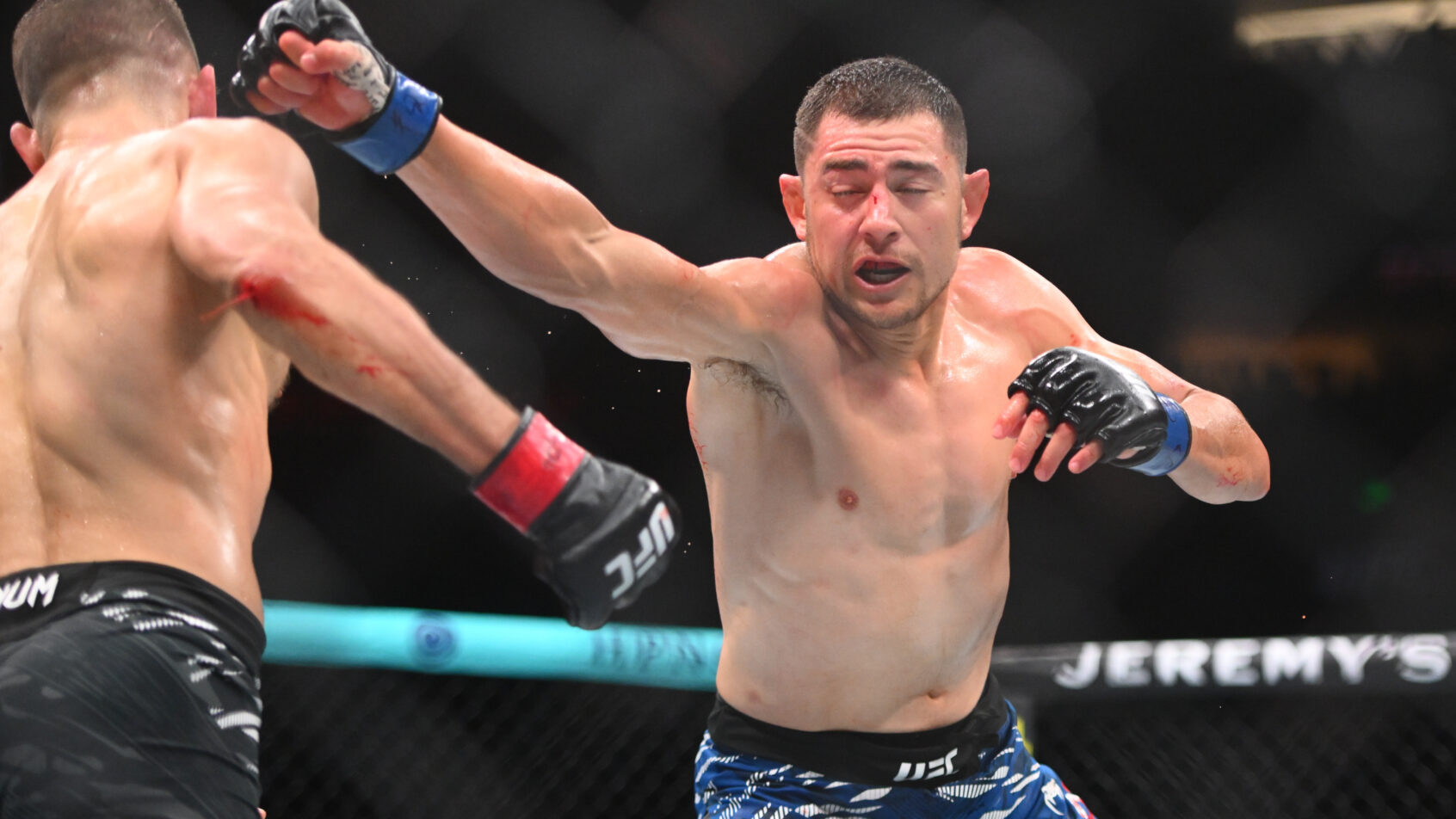Steve Garcia throws a punch at Calvin Kattar during their featherweight bout.