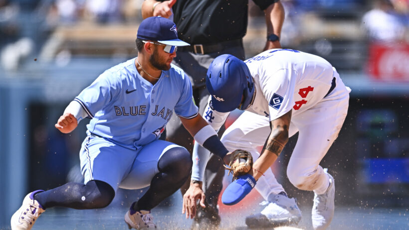 Los Angeles Dodgers outfielder Andy Pages slides into second as Toronto Blue Jays shortstop Bo Bichette tries to apply the tag