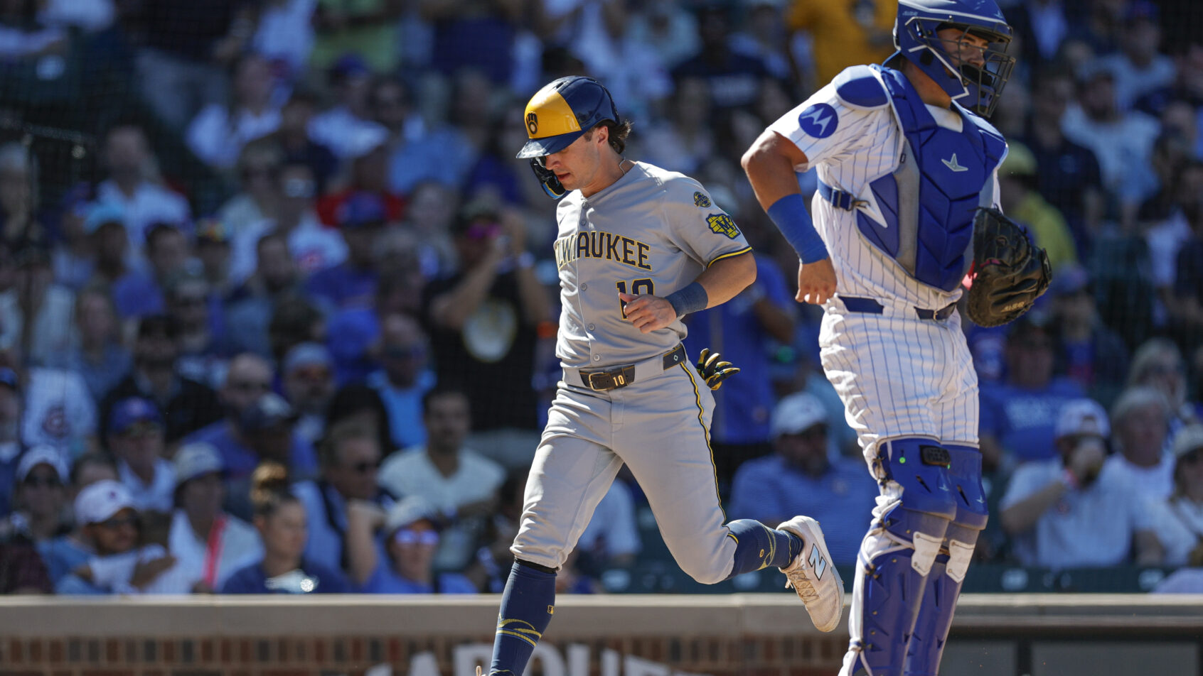 Milwaukee Brewers right fielder Sal Frelick crosses home plate against the Chicago Cubs
