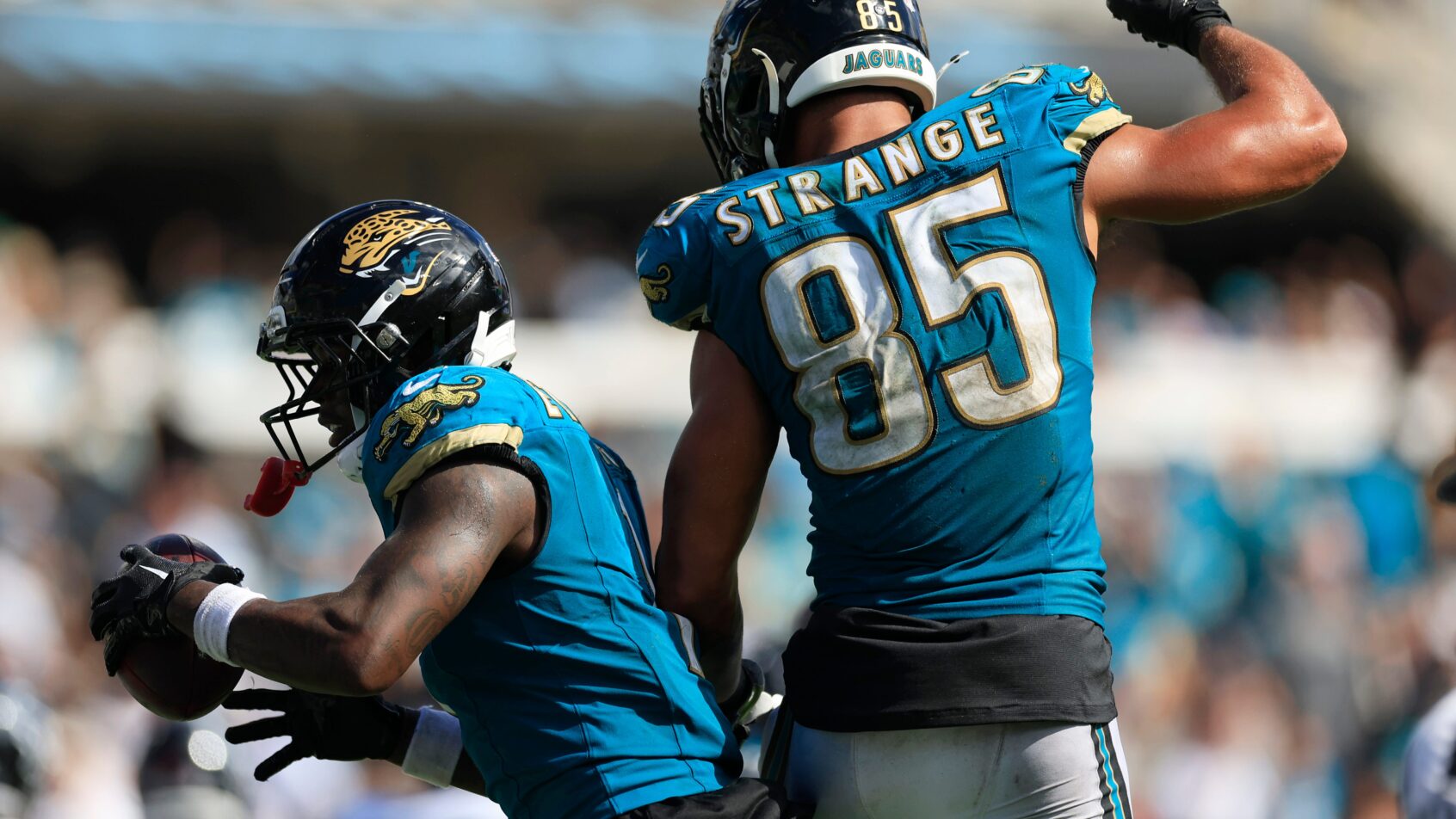 Brenton Strange and Travis Etienne celebrating after a Jaguars touchdown