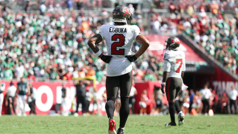 Tampa Bay Buccaneers wide receiver Emeka Egbuka on the field with arms akimbo