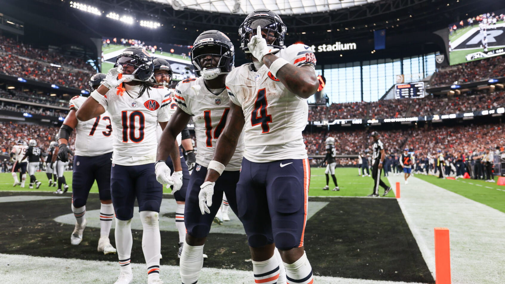 Chicago Bears running back d'Andre Swift quiets the crowd after scoring a TD