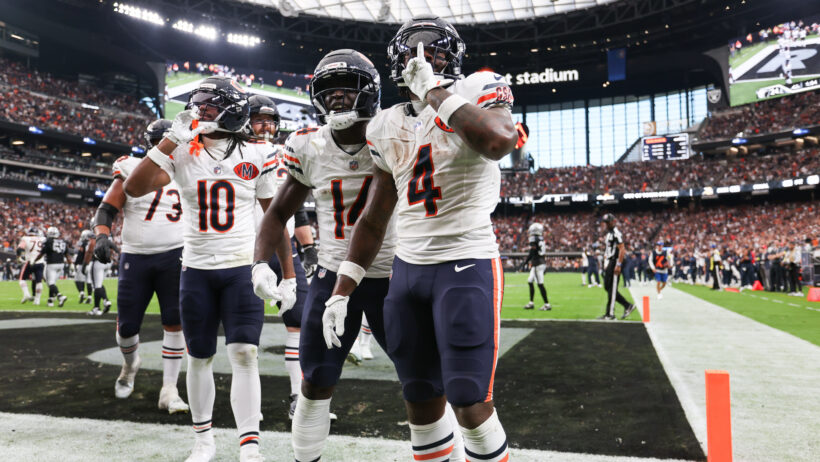 Chicago Bears running back d'Andre Swift quiets the crowd after scoring a TD