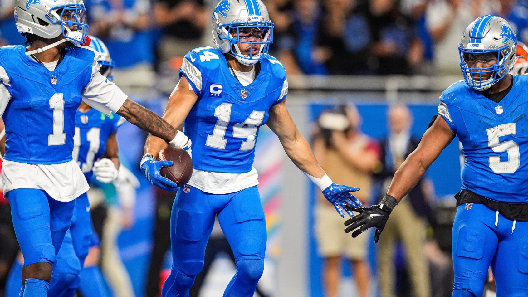 Detroit Lions wide receiver Amon-Ra St. Brown celebrates a TD with teammates
