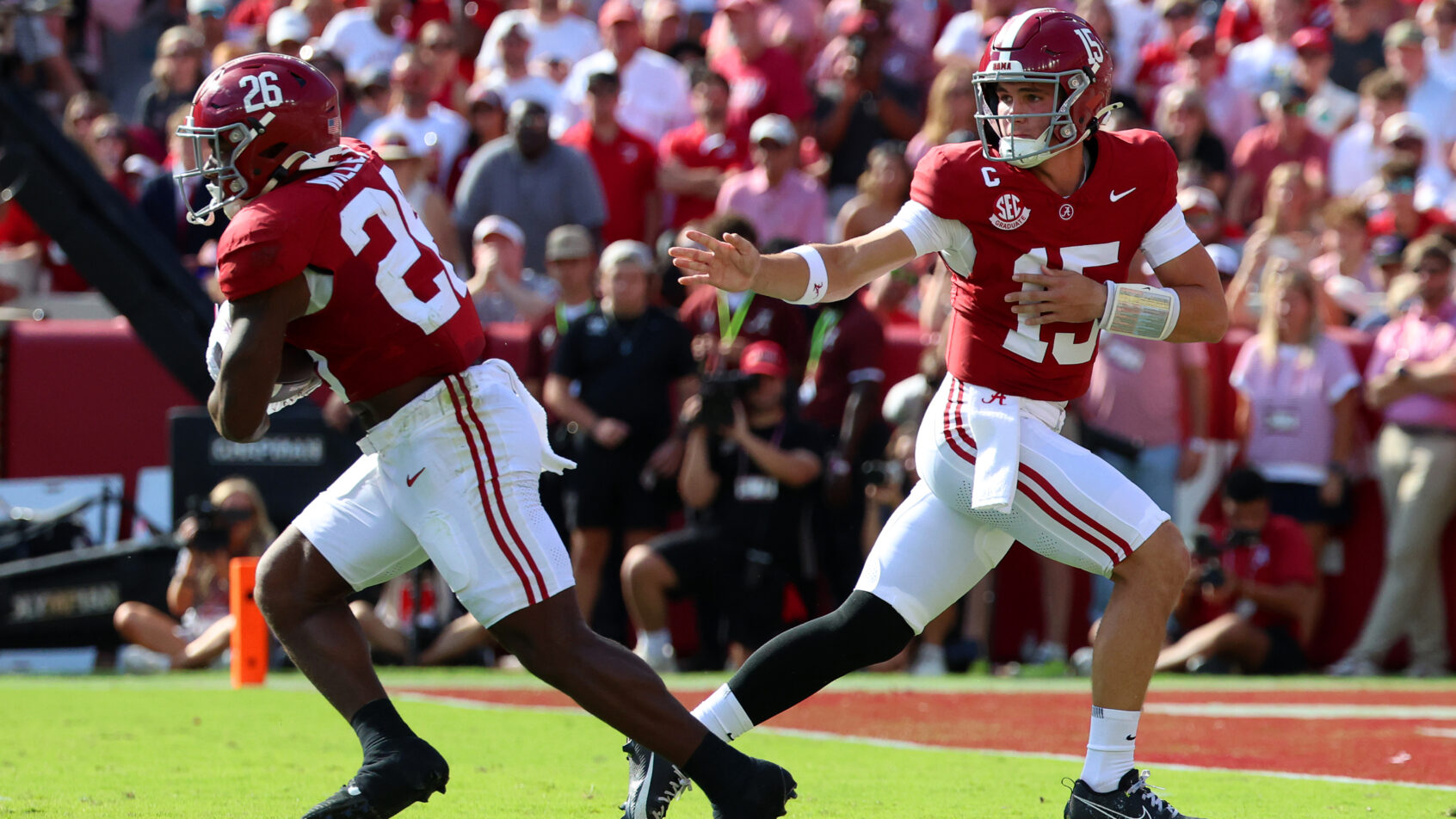 Ty Simpson hands the ball off to Jam Miller.