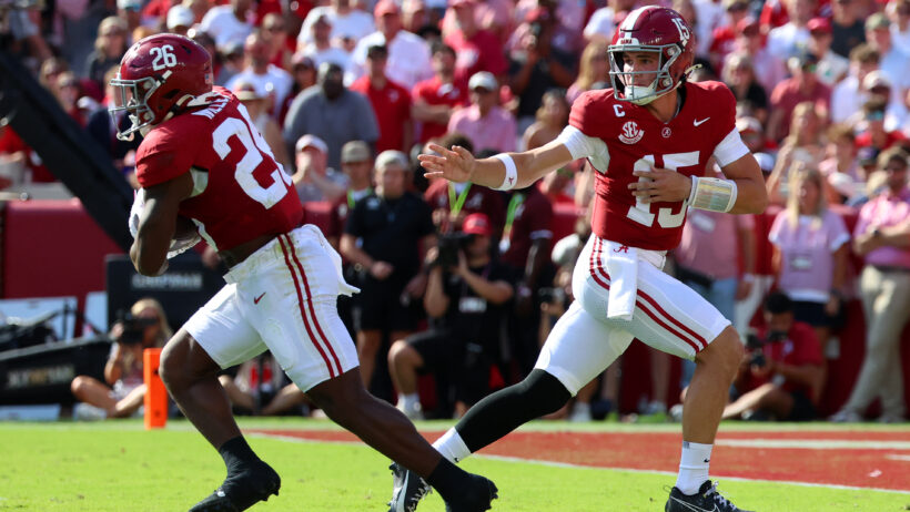 Ty Simpson hands the ball off to Jam Miller.