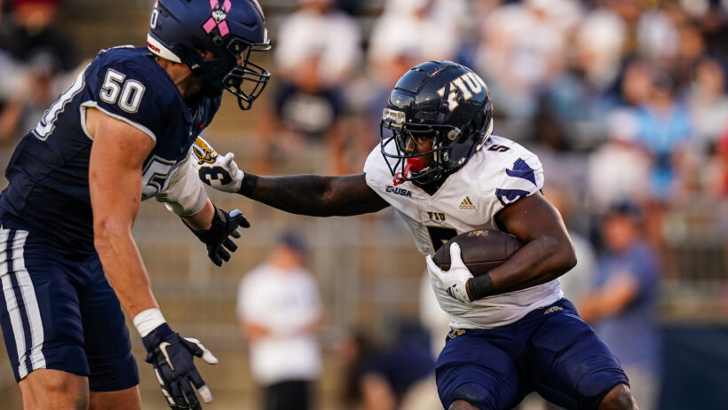 Kejon Owens carries the ball against UConn.