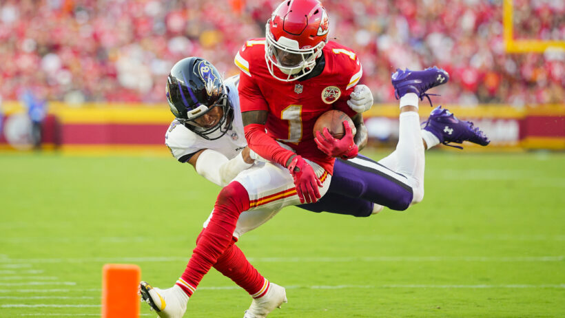 Kansas City Chiefs wide receiver Xavier Worthy gets tackled by Baltimore Ravens safety Kyle Hamilton