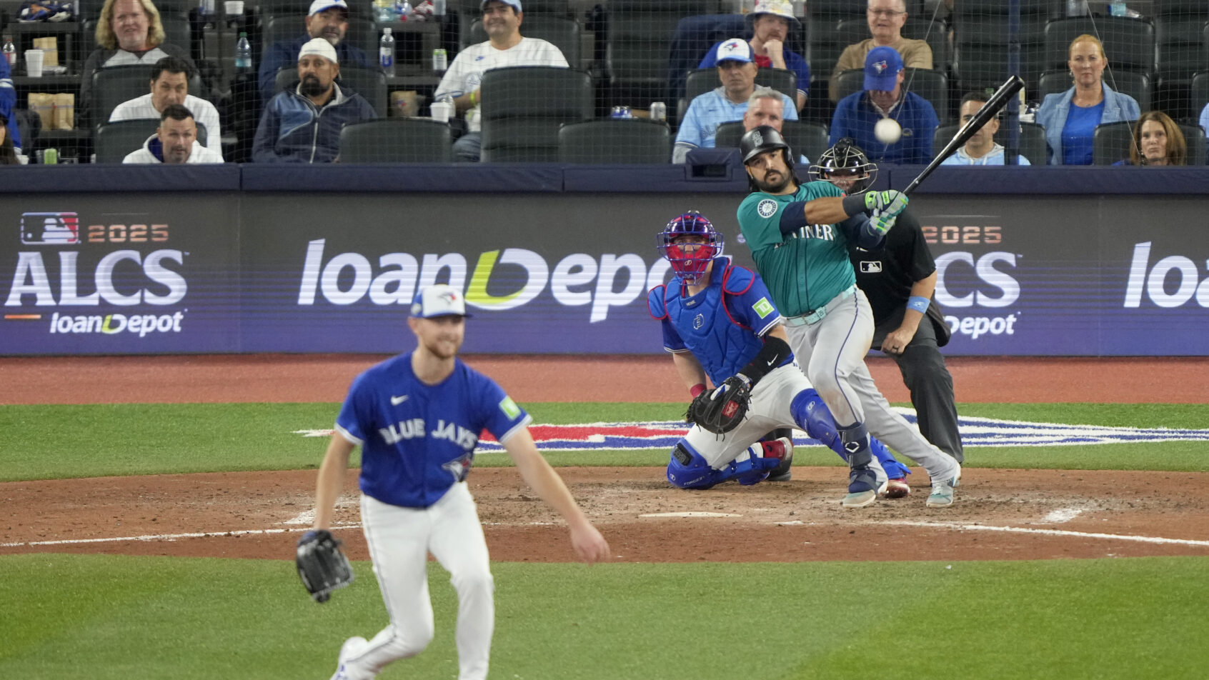 Seattle Mariners third baseman Eugenio Suarez hitting a single against the Toronto Blue Jays