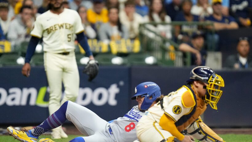 Los Angeles Dodgers left fielder Enrique Hernández scores a run