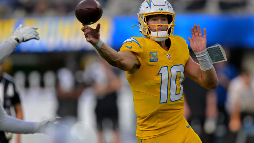 Justin Herbert throws a pass on the run versus the Colts.