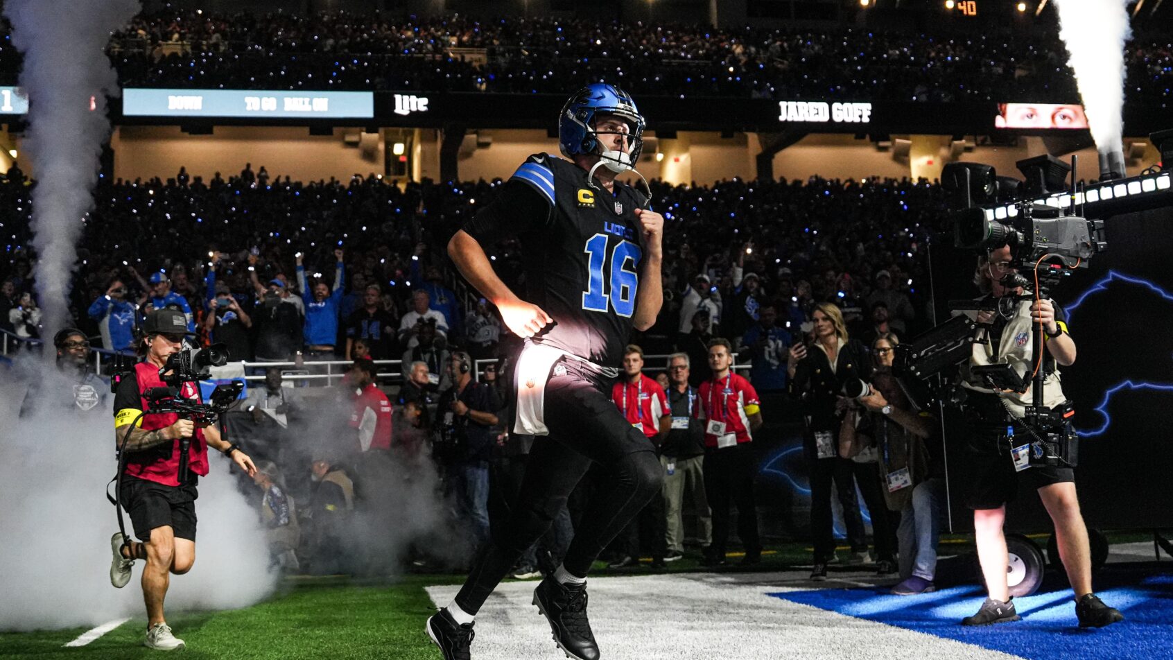 Detroit Lions quarterback Jared Goff running onto the field